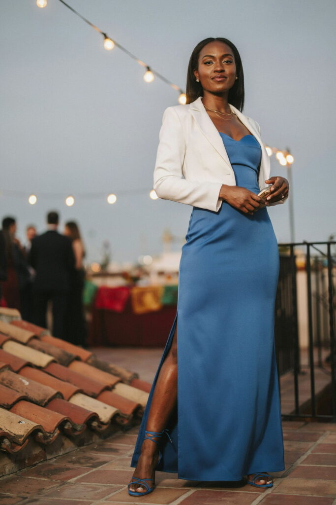 Cobalt blue strapless gown skirt paired with a fitted white cropped blazer, cobalt blue strappy heels, and gold stud earrings, creating a bold, modern Cinco de Mayo evening outfit for Black women with deep brown skin.