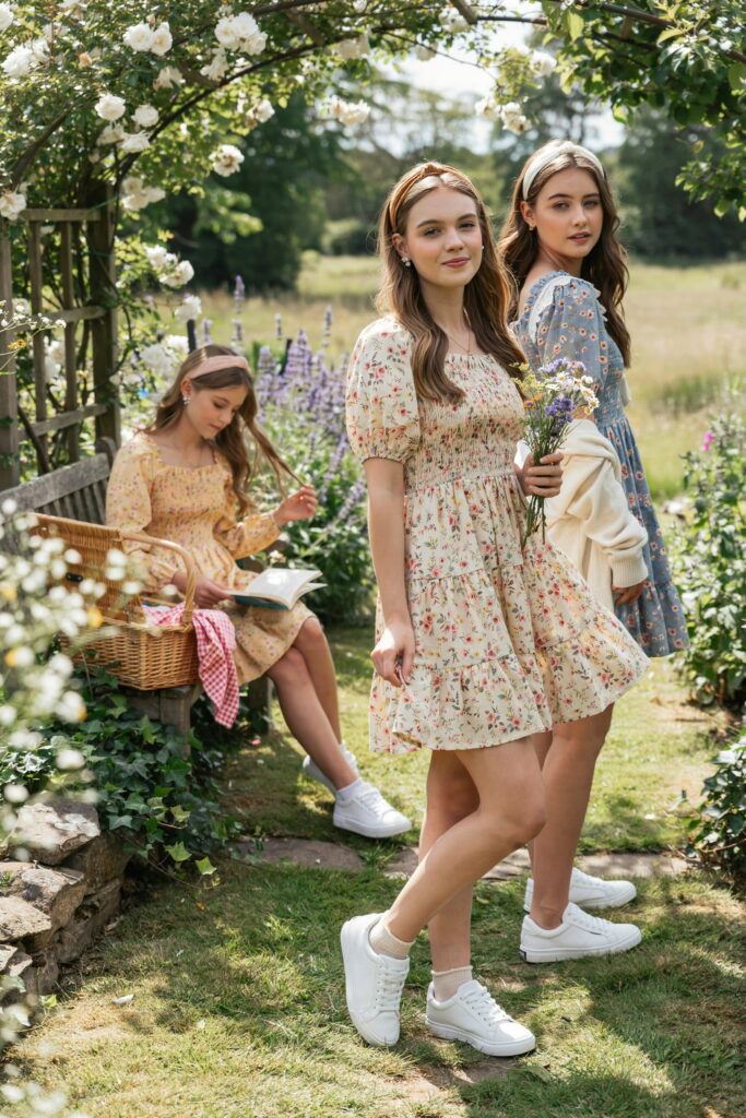 21 Cinco de Mayo Outfit Ideas for Teens That Look Cute and Seriously Trendy 14 Teen wearing a ditsy floral cottagecore mini dress with puff sleeves, crisp white sneakers, a ribbon headband, and small stud earrings for a sweet Cinco de Mayo outfit.