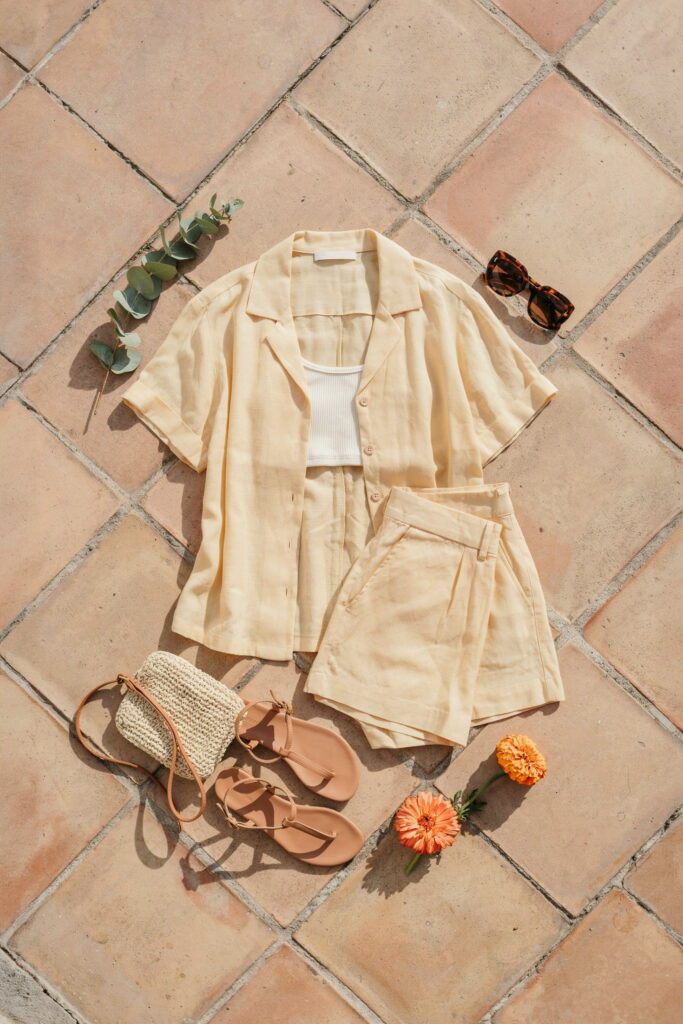 21 Cinco de Mayo Outfit Ideas for Teens That Look Cute and Seriously Trendy 13 Teen wearing a bright linen shorts and button-up shirt co-ord set over a bandeau with flat leather sandals and oversized sunglasses for a polished daytime Cinco de Mayo outfit