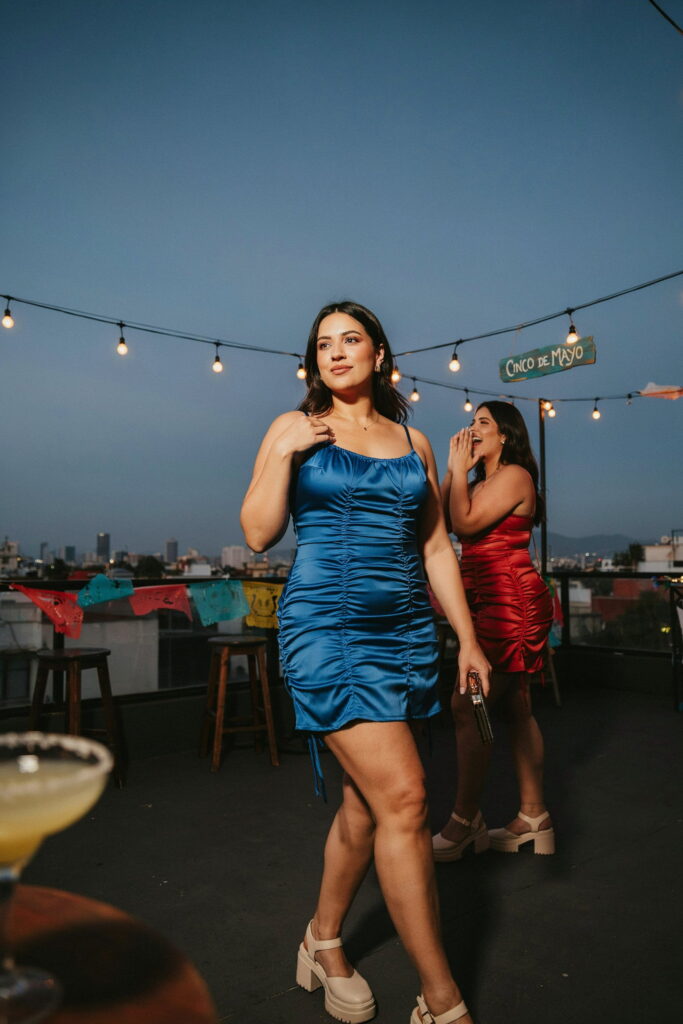 23 Plus Size Cinco de Mayo Outfit Ideas for the Cutest Fiesta Look Ever 6 Plus-size woman wearing a ruched satin mini dress in cobalt blue with platform sandals, creating a bold and flattering Cinco de Mayo evening outfit with elegant party style.